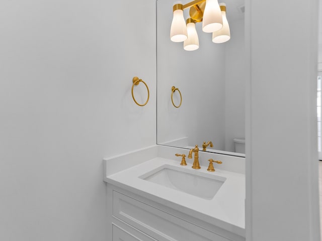 bathroom featuring vanity and toilet