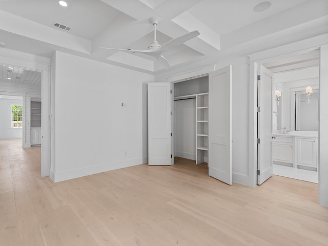 unfurnished bedroom featuring visible vents, baseboards, light wood-type flooring, connected bathroom, and coffered ceiling