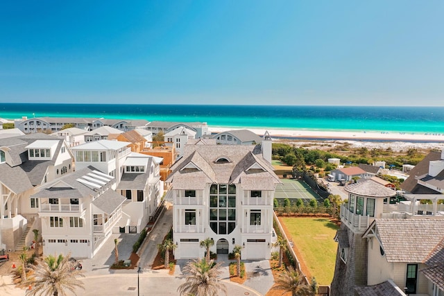 bird's eye view with a water view and a beach view