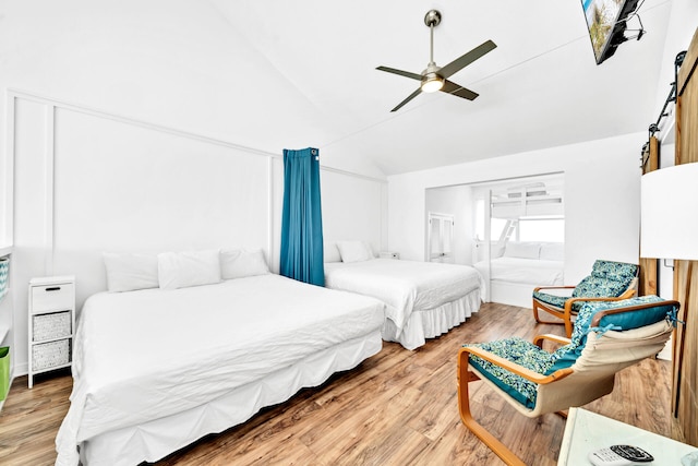 bedroom featuring vaulted ceiling, wood finished floors, and ceiling fan
