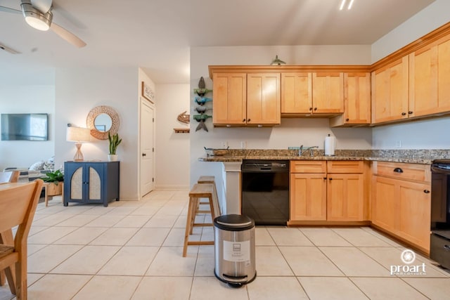 kitchen with black dishwasher, ceiling fan, stone countertops, and light tile patterned floors