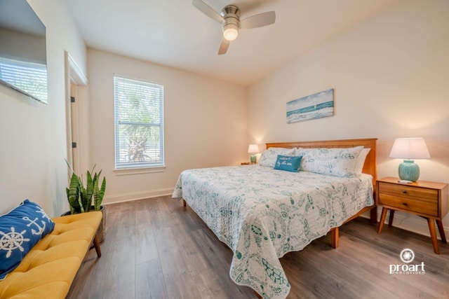bedroom featuring baseboards, ceiling fan, and wood finished floors