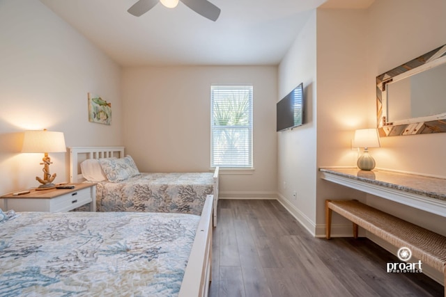 bedroom with baseboards, a ceiling fan, and wood finished floors