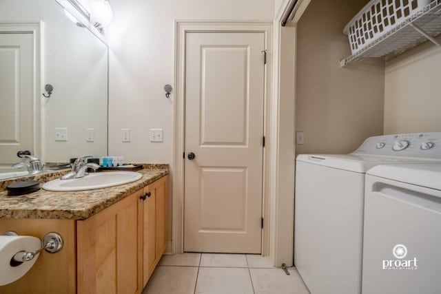 interior space featuring light tile patterned floors, separate washer and dryer, laundry area, and a sink