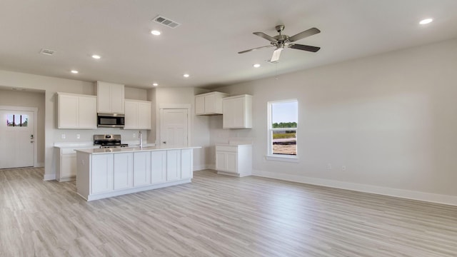 3068 Heritage Plantation Blvd, Laurel Hill, FL 32567 - kitchen with visible vents, baseboards, light wood-type flooring, a sink, and appliances with stainless steel finishes