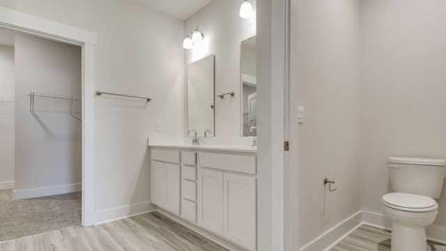 3068 Heritage Plantation Blvd, Laurel Hill, FL 32567 - bathroom featuring vanity, baseboards, toilet, and wood finished floors