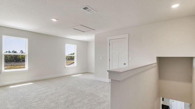3068 Heritage Plantation Blvd, Laurel Hill, FL 32567 - empty room featuring visible vents, light carpet, baseboards, attic access, and recessed lighting