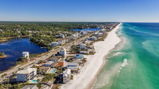 birds eye view of property featuring a beach view and a water view
