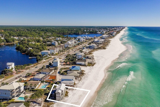 bird's eye view featuring a water view and a view of the beach