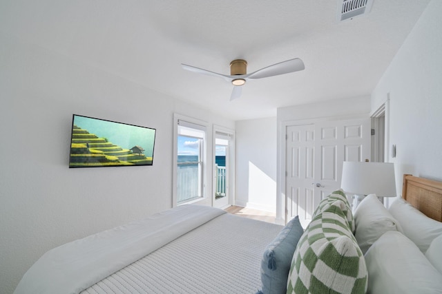 bedroom with a ceiling fan, visible vents, and a closet