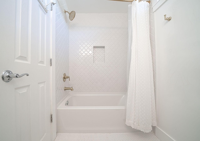 bathroom with shower / bath combo with shower curtain, baseboards, and tile patterned flooring
