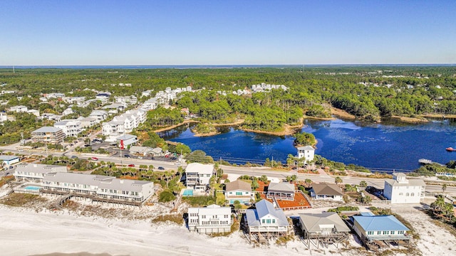 drone / aerial view with a residential view, a water view, and a wooded view
