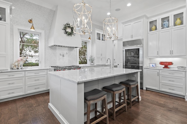 489 Regatta Bay Blvd, Destin, FL 32541 - kitchen with stainless steel built in refrigerator, white cabinetry, a sink, dark wood-type flooring, and glass insert cabinets