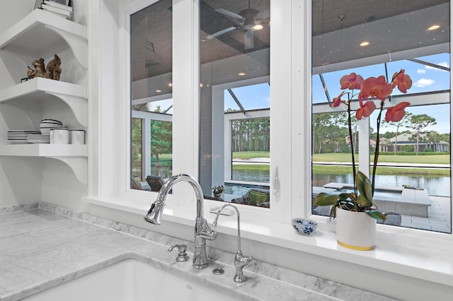 489 Regatta Bay Blvd, Destin, FL 32541 - kitchen view of a sink, a water view, open shelves, and light stone counters