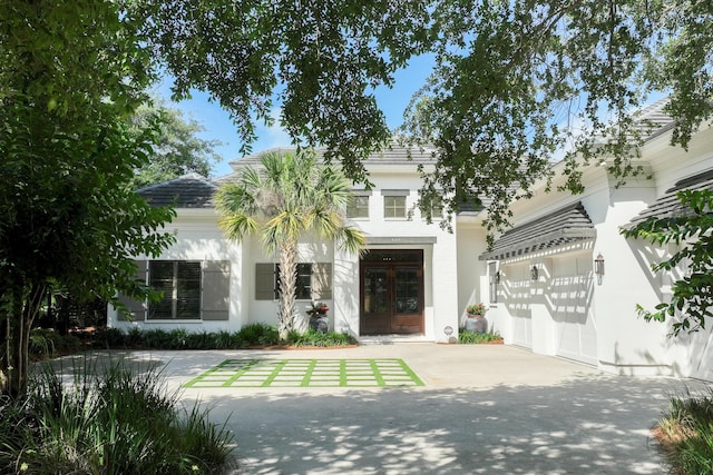 489 Regatta Bay Blvd, Destin, FL 32541 - view of front facade featuring french doors, concrete driveway, and stucco siding