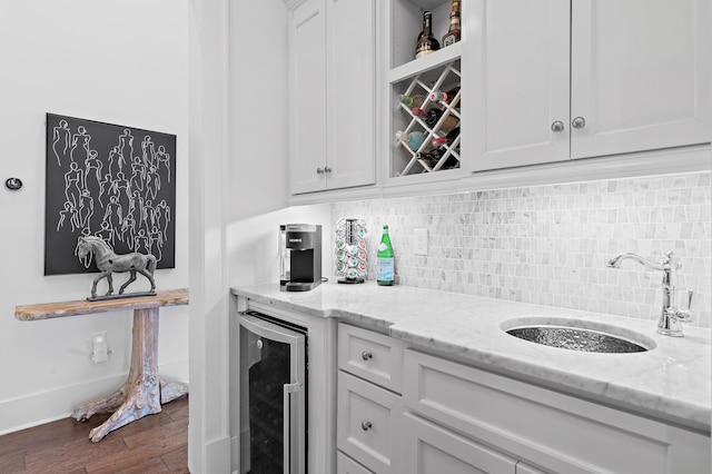 489 Regatta Bay Blvd, Destin, FL 32541 - indoor bar featuring beverage cooler, dark wood-type flooring, and backsplash