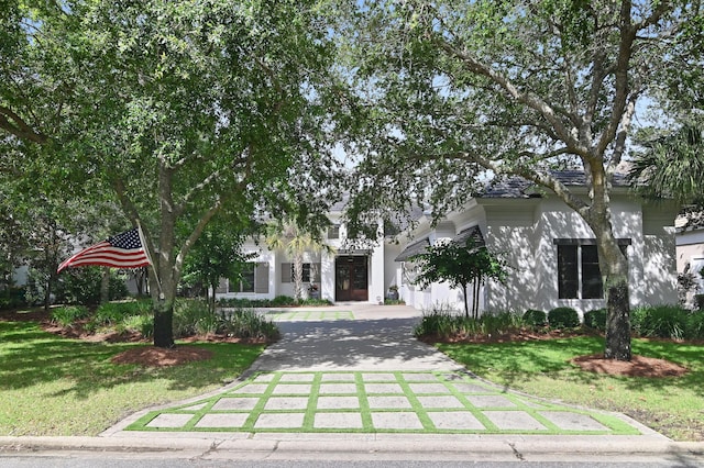 489 Regatta Bay Blvd, Destin, FL 32541 - obstructed view of property featuring driveway, a front yard, and stucco siding
