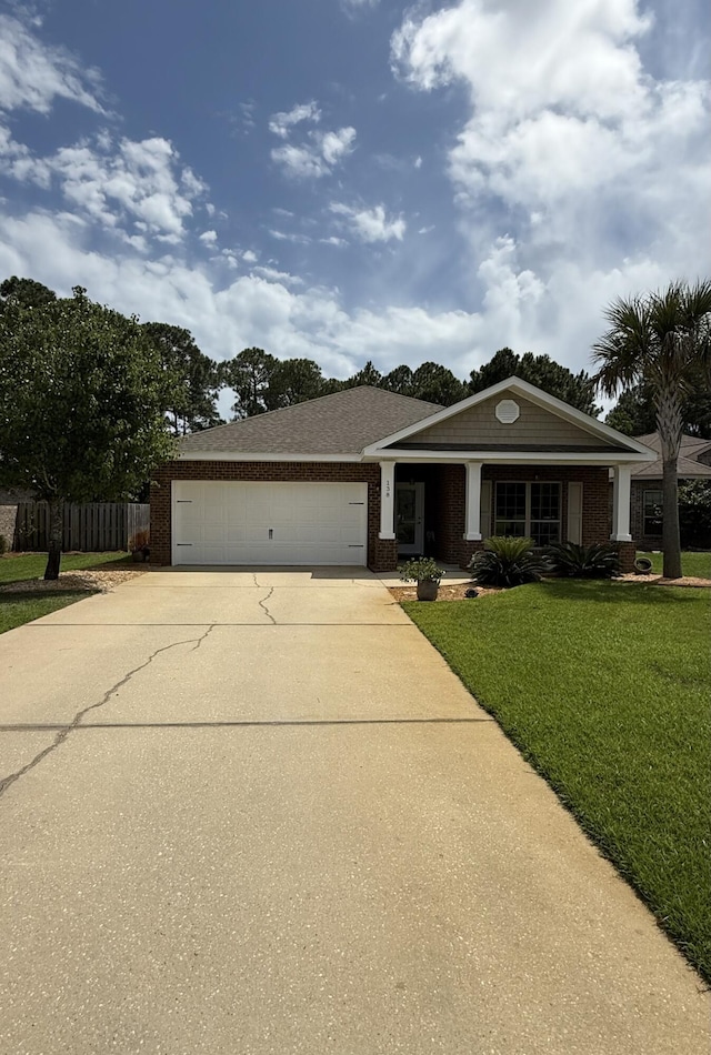 view of front of home with fence, brick siding, a garage, a front yard, and concrete driveway