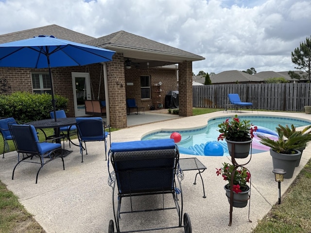 view of swimming pool with a patio, fence, and a fenced in pool