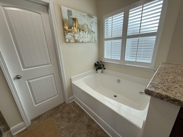 full bath featuring a garden tub and tile patterned floors