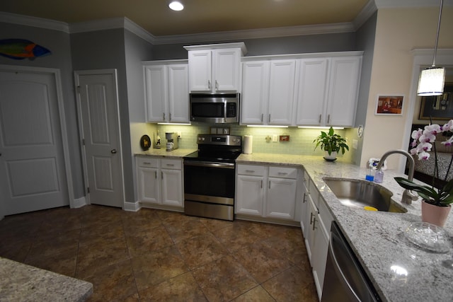 kitchen featuring light stone counters, a sink, stainless steel appliances, white cabinetry, and tasteful backsplash
