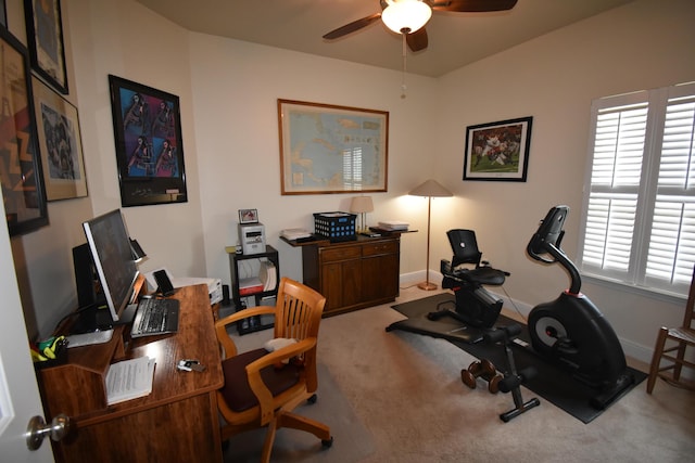office area with baseboards, carpet, and ceiling fan