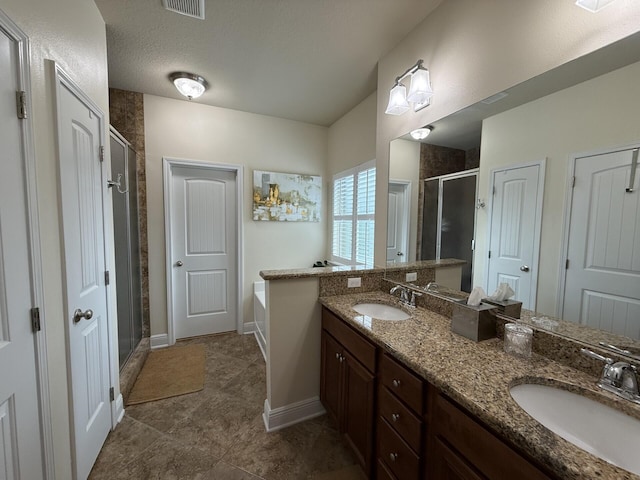 bathroom with double vanity, a sink, a bath, and a shower stall