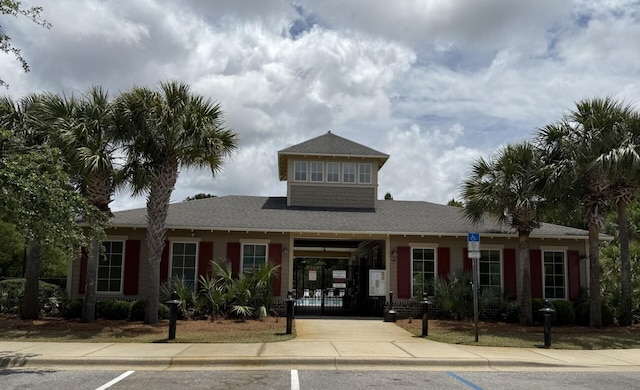 view of front of house featuring a gate and roof with shingles