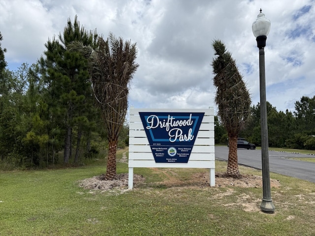 community / neighborhood sign with a lawn