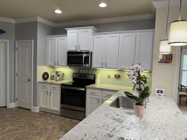 kitchen featuring appliances with stainless steel finishes, white cabinets, decorative backsplash, and light stone counters