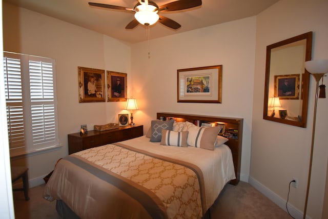 carpeted bedroom featuring baseboards and ceiling fan