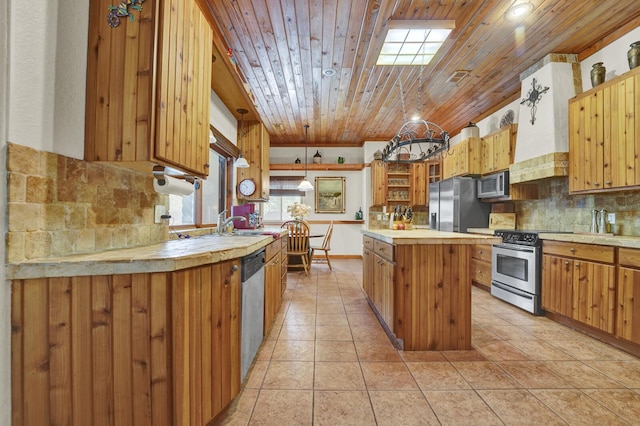 35 Blue Bayou Dr, Santa Rosa Beach, FL 32459 - kitchen featuring appliances with stainless steel finishes, open shelves, a center island, light countertops, and decorative backsplash