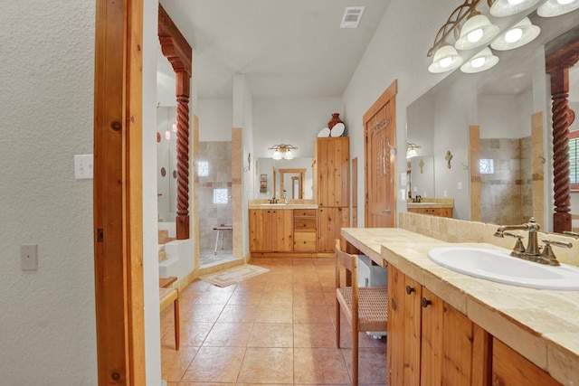 35 Blue Bayou Dr, Santa Rosa Beach, FL 32459 - bathroom with a stall shower, two vanities, tile patterned floors, and plenty of natural light