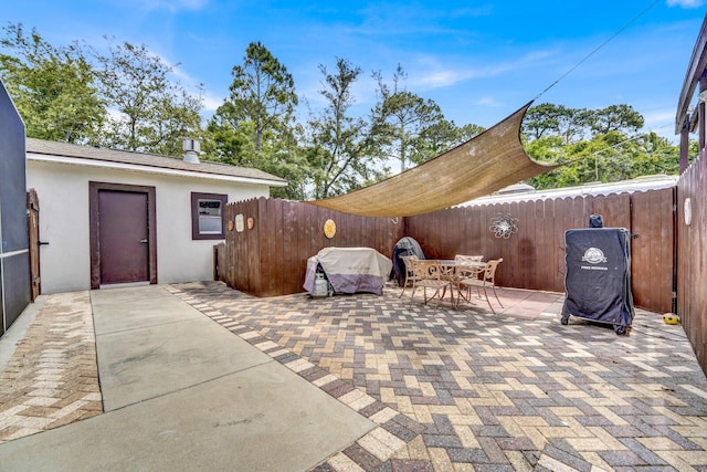 35 Blue Bayou Dr, Santa Rosa Beach, FL 32459 - fenced backyard featuring a patio, outdoor dining space, and a grill