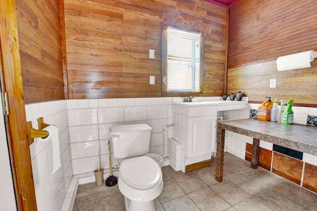 35 Blue Bayou Dr, Santa Rosa Beach, FL 32459 - bathroom featuring wood walls, toilet, and tile patterned flooring
