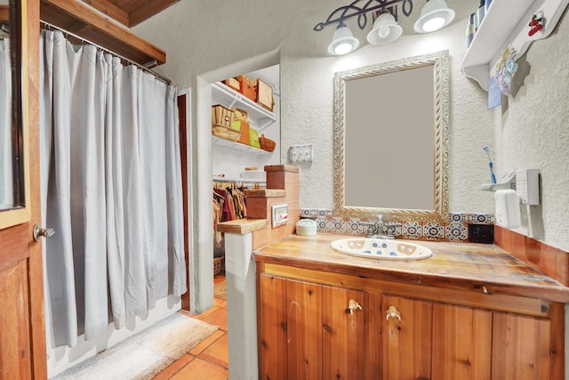 35 Blue Bayou Dr, Santa Rosa Beach, FL 32459 - full bathroom featuring a shower with curtain, tile patterned flooring, a textured wall, and vanity