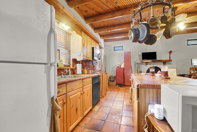 35 Blue Bayou Dr, Santa Rosa Beach, FL 32459 - kitchen with freestanding refrigerator, stainless steel microwave, dishwasher, a sink, and wooden ceiling with exposed beams
