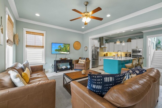 living area featuring crown molding, a ceiling fan, recessed lighting, and light colored carpet