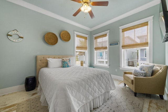 bedroom with baseboards, crown molding, and ceiling fan