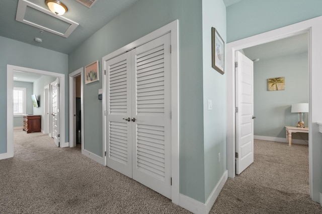 corridor with carpet flooring and baseboards