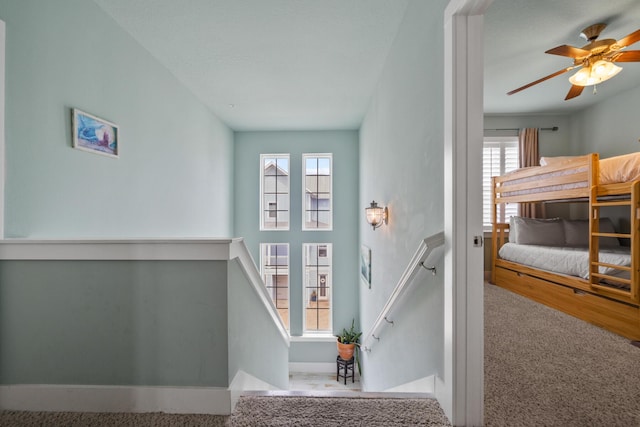 doorway with carpet floors and a ceiling fan