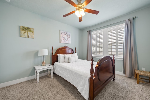 bedroom with carpet flooring, baseboards, and a ceiling fan