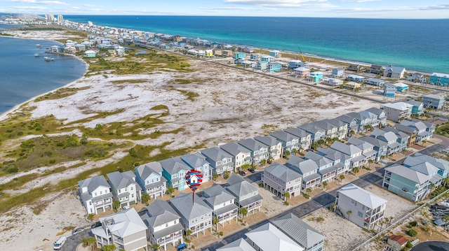 aerial view of residential area featuring waterfront with a beach
