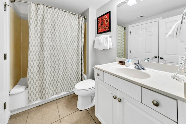 bathroom with toilet, vanity, shower / tub combo with curtain, visible vents, and tile patterned floors