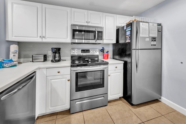 kitchen with white cabinetry, light countertops, light tile patterned floors, and appliances with stainless steel finishes