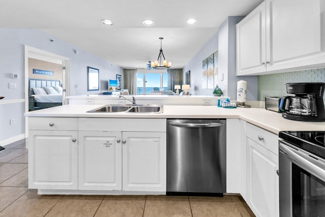 kitchen with a sink, a peninsula, open floor plan, white cabinets, and stainless steel dishwasher