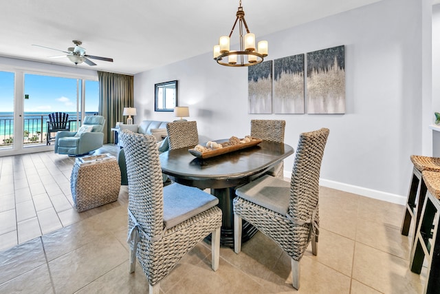 dining space with light tile patterned flooring, baseboards, and ceiling fan with notable chandelier