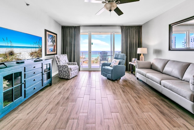 living area with ceiling fan and wood finished floors