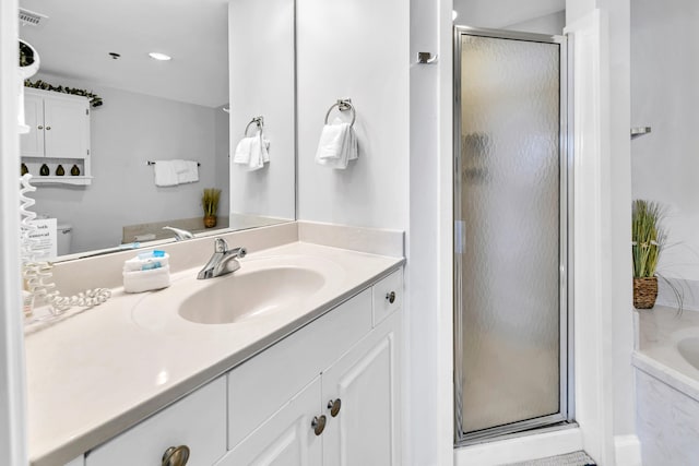 bathroom featuring vanity, a garden tub, a shower stall, and visible vents