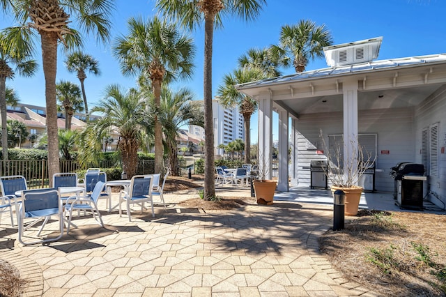 view of patio featuring a grill and fence